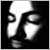 Black-and-white pixelated icon showing a stylized face with large circular eyes and a broad nose, set against a solid black background.
