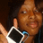 A person holds a white and black device with blue accents, making a peace sign with their hand in a pixelated image.