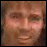 Pixelated of two faces with blue text and a poop emoji on white background