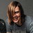 Pixelated image of a person with shoulder-length brown hair wearing a gray shirt, next to pixelated text reading "Ronnie Winter" and a heart symbol on white background.