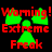 Static pixel art displays red text 'Worming! Extreme Freak' over green shapes on black background.