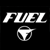 Static black-and-white pixelated icon featuring the word "FUEL" in bold stylized letters above a circular logo with a central triangular shape and horizontal bar.