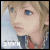 Pixelated anime-style character with blonde hair and blue eyes, wearing a red shirt under dark clothing, displayed in a of