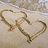 Two heart outlines drawn in sand with text reading 'All I Want Is YOU!!' on a beach background.