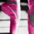 A pink and gray abstract shape rotates clockwise against a white and black striped background.