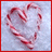 Red background with a heart-shaped candy cane on light gray, white pixelated text reading 'All I want for Xmas is U!!!' and a dotted line below the image.