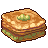 Pixelated sandwich with browned bread, green leafy filling, and a small green garnish on top against gray background.
