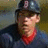 A person wearing a dark baseball cap with red 'B' logo, dark blue jersey, and red collar appears in three showing slight head position changes