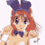 Pixelated character with red hair, blue bow tie, and purple headpiece, wearing white and beige clothing against a plain background.