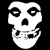 Static pixelated white skull icon on black background with large hollow eyes, open mouth, and visible teeth.