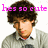 A pixelated image of a person with curly brown hair wearing a light gray sweater over a white collared shirt, displayed in three with varying text overlays
