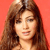 Static pixelated image of a person with long brown hair against an orange background, rendered in low-resolution style typical of early 2000s buddy icons.
