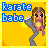 Pixel art buddy icon featuring a cartoon character with long brown hair and blue eyes holding a gray object against a yellow background, with "karate babe" text in blue pixelated letters.