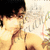 Pixelated image of a person with dark hair and light skin, wearing a white shirt against a bright background.