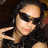 A person with long dark hair and sunglasses makes a peace sign, wearing a sleeveless top in three sequential poses.