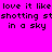 Pixelated text on bright pink background with blue rectangular overlays, showing repeated phrases 'love it like love it like' and 'shooting st in a sky'.