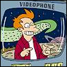 Pixelated cartoon character with orange hair and red jacket points at viewer inside rounded television frame with 'VIDEOPHONE' text above.
