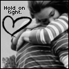 Black-and-white photo of a person in striped clothing embracing another person with a heart symbol and text "Hold on tight." visible.