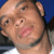 Two side-by-side pixelated images of a person with light brown skin, one showing the face turned left against blue background and the other right against dark background.