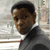 Static 50x50 pixel icon showing a close-up of a person in formal attire against a blurred background with light and dark tones.
