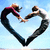 Two figures in dynamic poses form a heart shape against a light blue background, with one figure wearing dark clothing and the other in pink and brown tones.