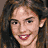 Animated contact sheet of three pixelated frames showing a woman with long brown hair and red lipstick smiling in different lighting conditions.
