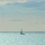 Pixelated static image of a sailboat on calm water under a gradient sky with soft blue and beige tones.