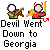Pixelated cartoon devil with red horns and tail holding a guitar, standing next to another figure in yellow clothing against gray background.