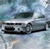 A pixelated static image shows a white vehicle with dark windows and black accents against a blurred blue and gray background.