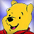 Static pixelated image of a yellow cartoon bear with black facial features, pink tongue, and red shirt against blue gradient background.