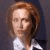 Static image of a person with light brown hair wearing a white collared shirt against dark background, next to green text reading Original Icons .com.