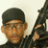 Pixelated image of a person wearing a dark cap and dark clothing holding a large dark firearm against a light background.