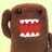Brown plush character with large black eyes and red mouth showing white teeth, displayed in a four