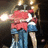 Two figures in red and blue clothing embrace under bright lights, with text overlays changing between frames.