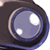 Static pixelated icon of a large blue lens with two white highlights on a dark background, resembling an eye or camera lens.