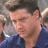 Pixelated static image of a person in blue clothing with dark hair, visible facial features including eyes and nose, against an indistinct background.