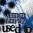 Static image of repeated text 'LOVE ME LIKE YOU USED TO' in blue and black pixelated font over a blue-and-white striped background with scattered dark circular shapes.