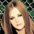Pixelated close-up of a person with light brown hair and closed eyes against a green and black checkered background.