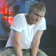 identical animated frames showing a person in a white t-shirt leaning forward with changing facial expressions against a red and blue background