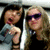 Two women in a split-screen view; one woman holds a gray object near her mouth while the other wears purple sunglasses, with subtle expression changes across frames.