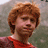 A pixelated image of a person with red hair in three distinct views showing different clothing and backgrounds.