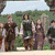 Six show a character with long brown hair in various scenes: walking outdoors, standing near water with arrows on back, and holding a map