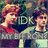Two pixelated figures with light brown hair and red accents stand side-by-side against a dark, multicolored background with visible text.