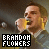 A 4x3 contact sheet of animated frames showing a man singing into a microphone with "BRANDON FLOWERS" text in pixelated font, displayed on a gray background.