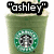 Green Starbucks drink with whipped cream and a green straw, featuring text overlays "ashley", "omg", and "it calls me" in black boxes.