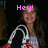 A person with long dark hair wearing a strapless top holds a white and red object, with pink text changing across frames.