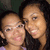 Two people with dark hair and light skin pose closely together in a pixelated image, smiling at the camera.