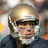Pixelated image of a football player in a helmet with orange text on blue background reading GO BRADY QUINN!! COLLEGE NOTRE DAME QB NFL TEAM BROWNS QB