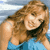 Static pixelated image of a person with long brown hair wearing a blue top and black choker, set against a light blue background.