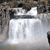 A static pixelated image shows a white rectangular shape with faint vertical lines against a dark, blurred background.